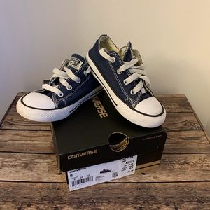 Navy blue kids/toddler Converse sneakers.